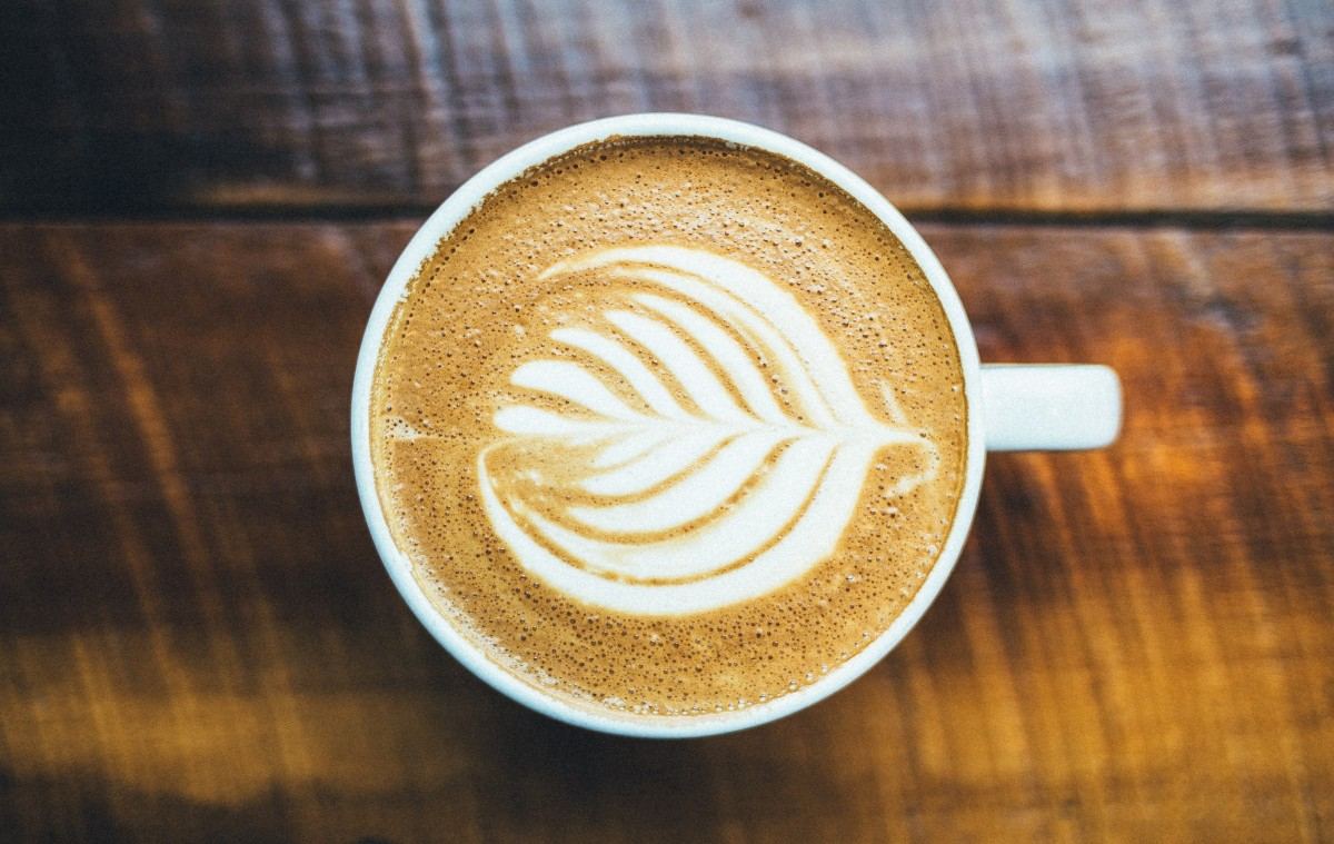 Cup of cappuccino on a wooden cafe table